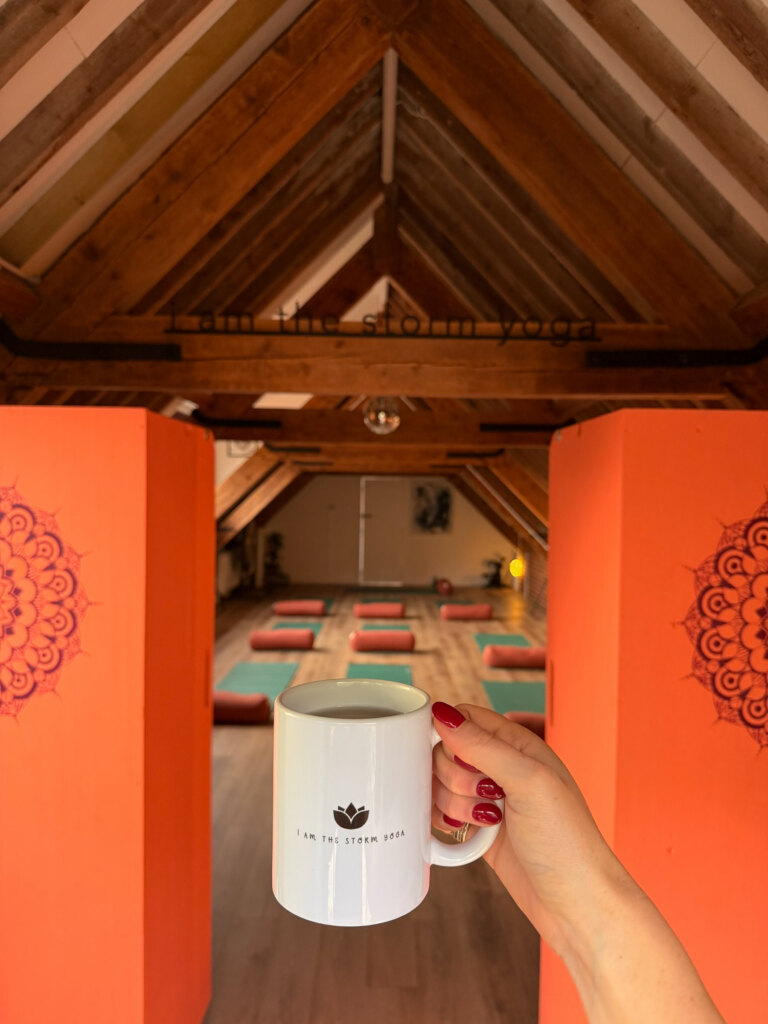 A mug of coffee beside the mandala doorway at the yoga studio